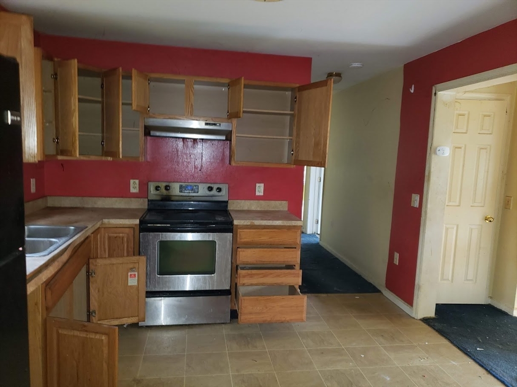 21 Spencer Road Oakham, MA 01068 - Photo 3 of 25 a kitchen with a stove and a microwave
