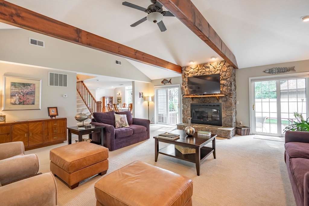 33 Mountain Brook Road Sturbridge, MA 01566 - Photo 16 of 41 a living room with furniture fireplace and a large window