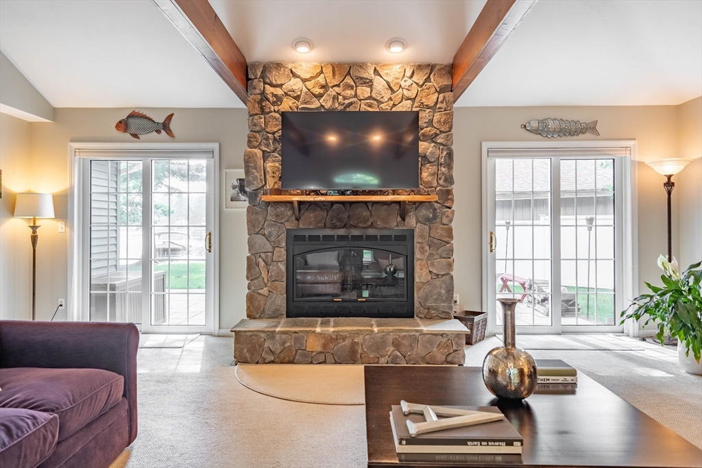 33 Mountain Brook Road Sturbridge, MA 01566 - Photo 17 of 41 a living room with furniture a fireplace and a flat screen tv