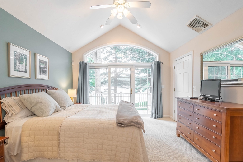 33 Mountain Brook Road Sturbridge, MA 01566 - Photo 23 of 41 a bedroom with a large bed and a chandelier