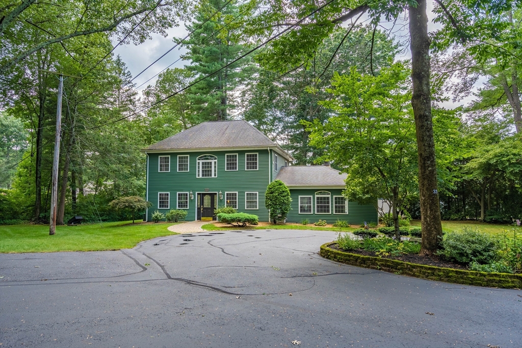 33 Mountain Brook Road Sturbridge, MA 01566 - Photo 3 of 41 a view of a patio with a table and chairs under an umbrella
