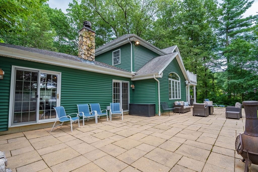 33 Mountain Brook Road Sturbridge, MA 01566 - Photo 31 of 41 a view of house with backyard and sitting area