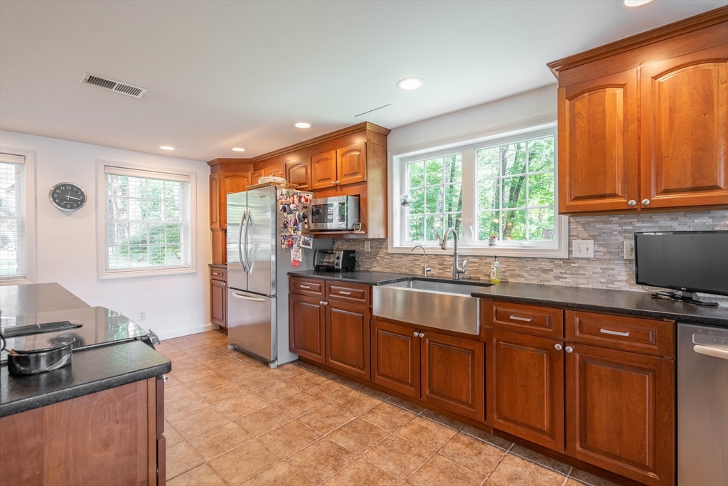 33 Mountain Brook Road Sturbridge, MA 01566 - Photo 10 of 41 a kitchen with stainless steel appliances granite countertop sink stove and large window