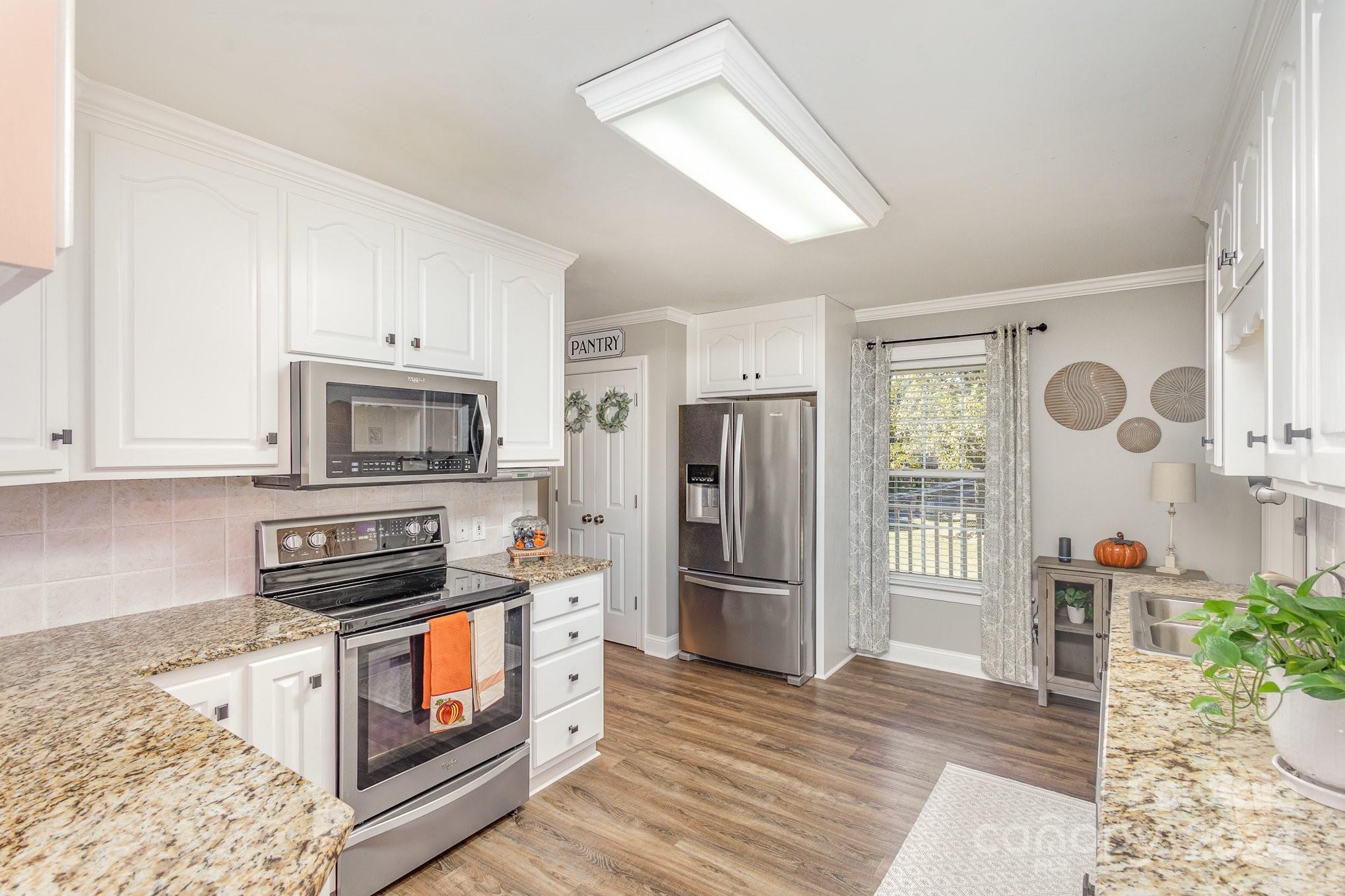 13512 Five Point Road Locust, NC 28097 - Photo 12 of 31 a kitchen with stainless steel appliances a stove a refrigerator and a sink