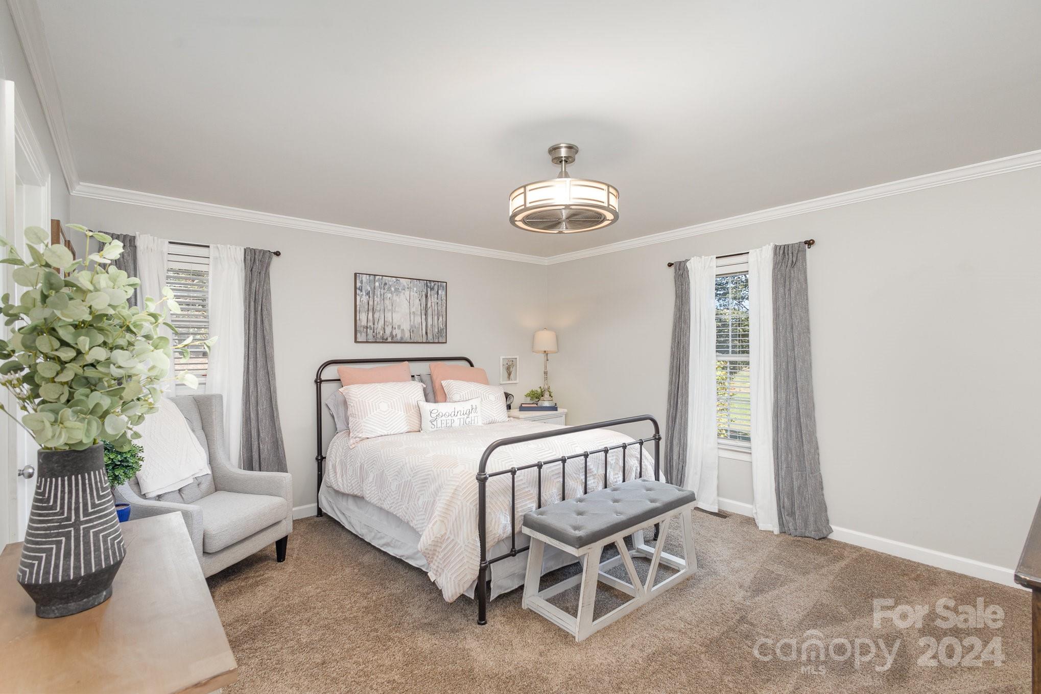 13512 Five Point Road Locust, NC 28097 - Photo 16 of 31 a bedroom with a bed and a chandelier