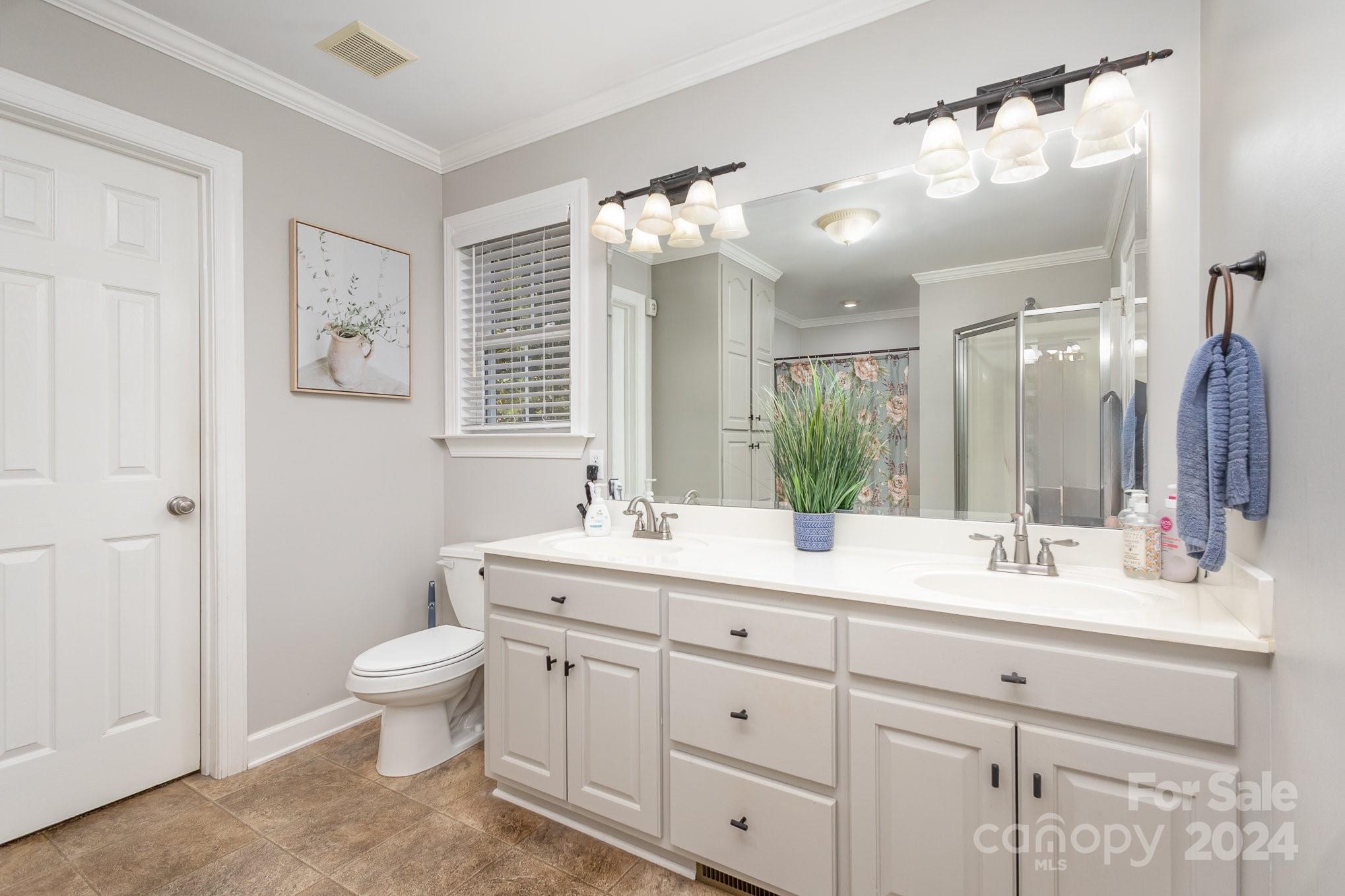 13512 Five Point Road Locust, NC 28097 - Photo 18 of 31 a bathroom with a double vanity sink and a mirror