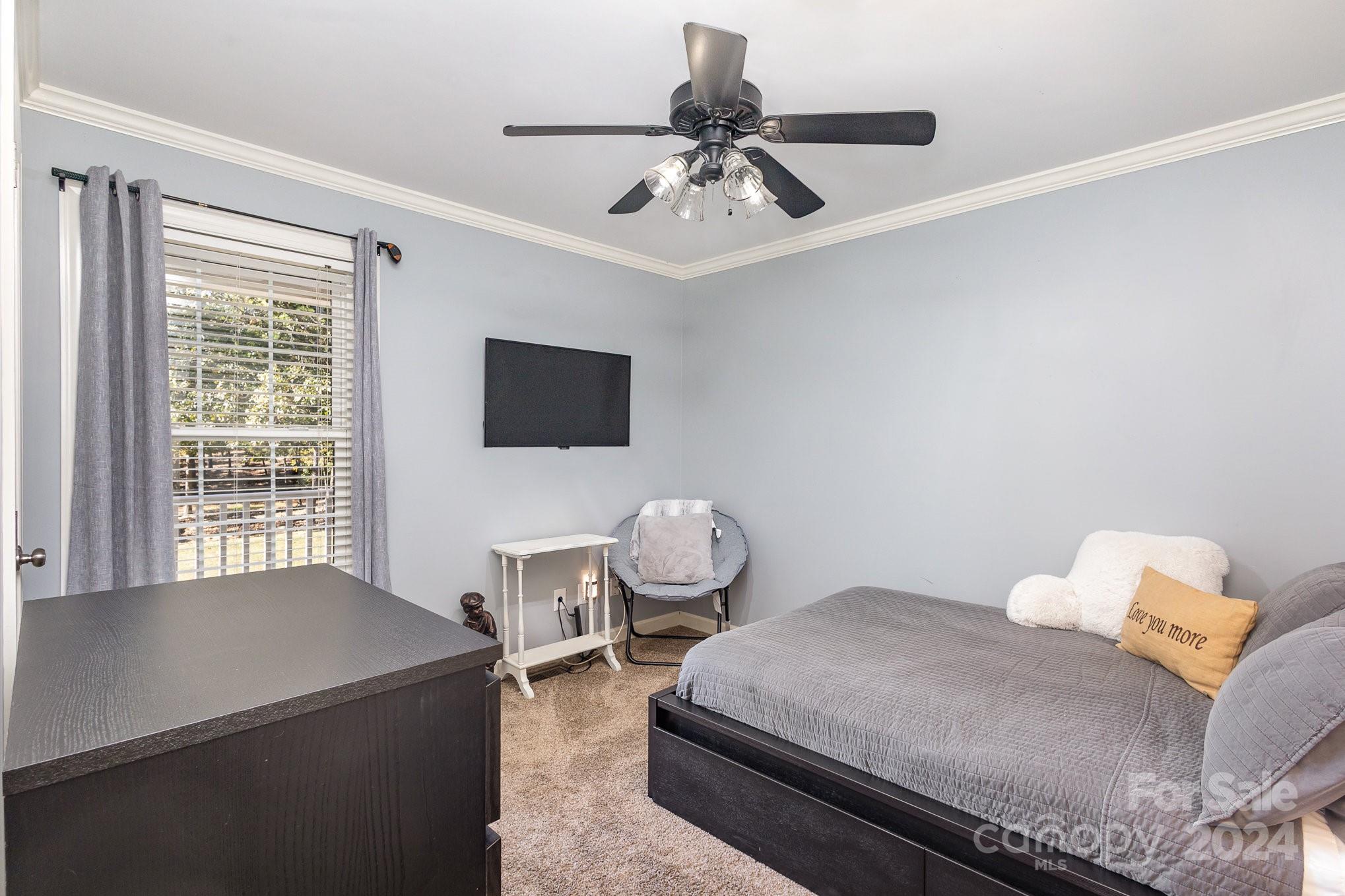 13512 Five Point Road Locust, NC 28097 - Photo 20 of 31 a bedroom with a bed and flat screen tv