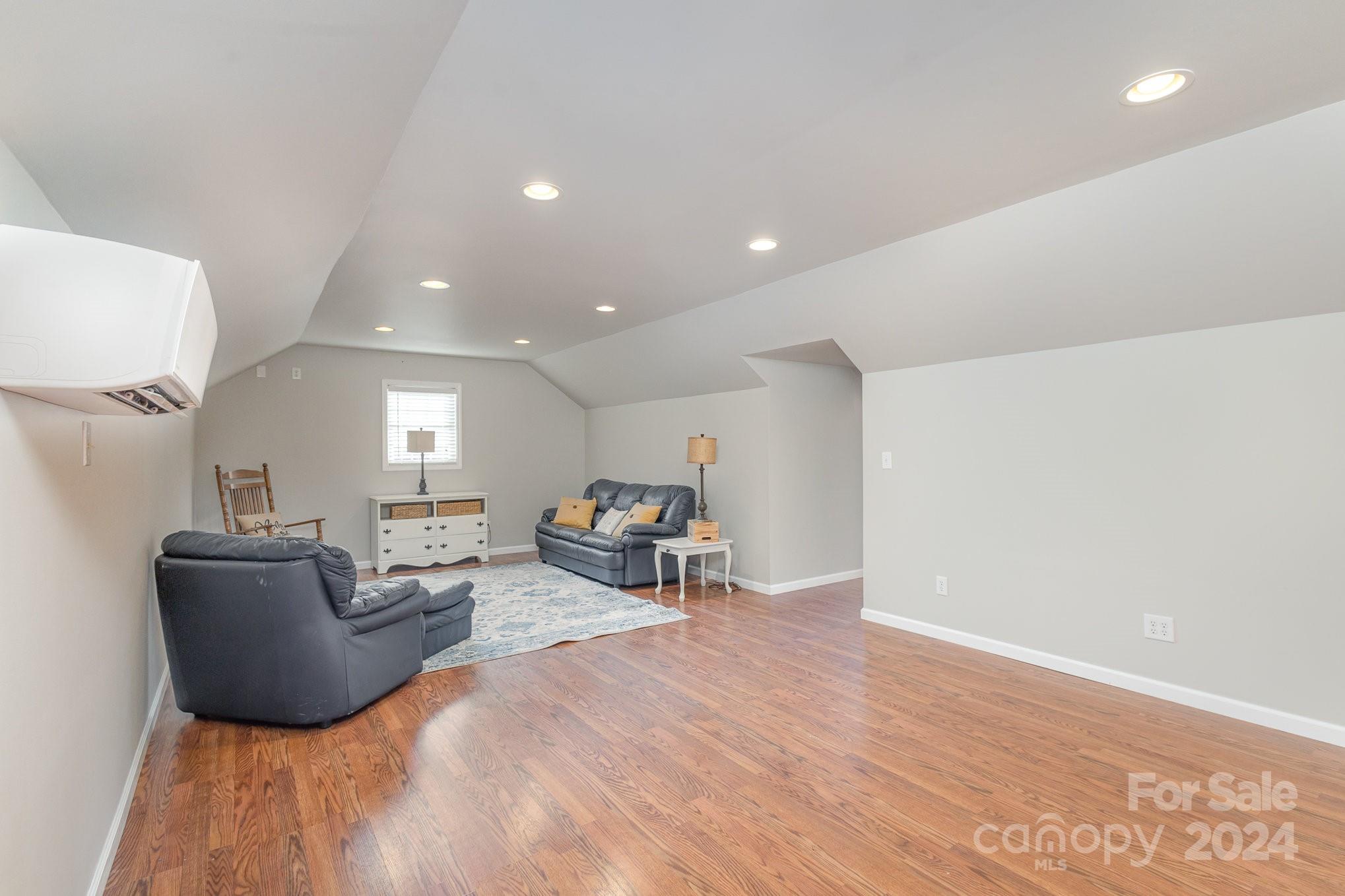 13512 Five Point Road Locust, NC 28097 - Photo 26 of 31 a living room with furniture and a wooden floor
