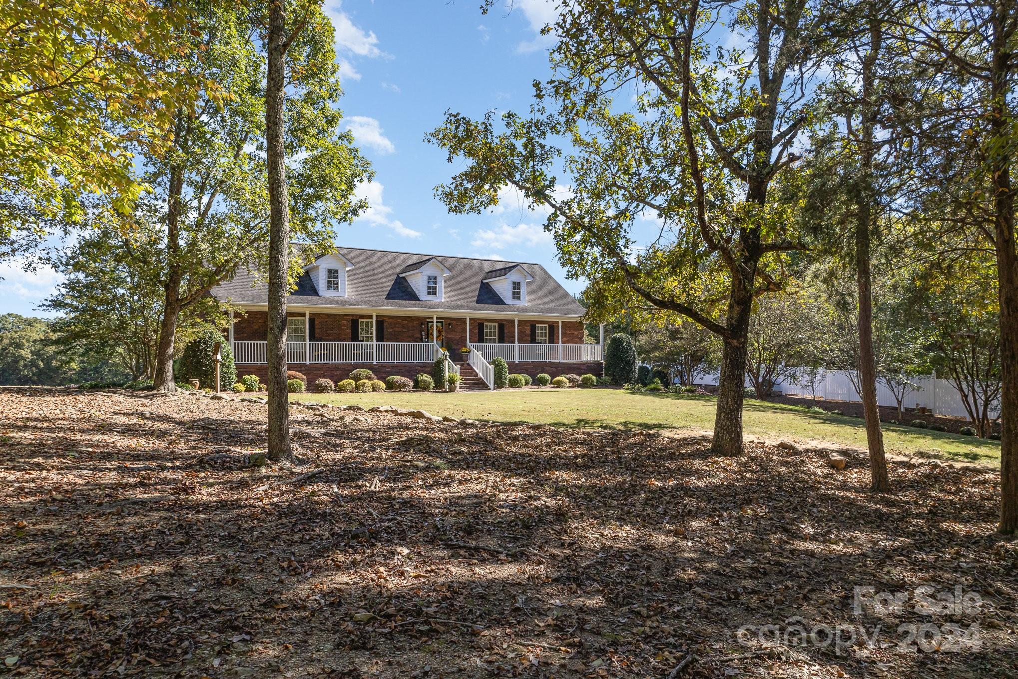 13512 Five Point Road Locust, NC 28097 - Photo 3 of 31 a house with trees in the background