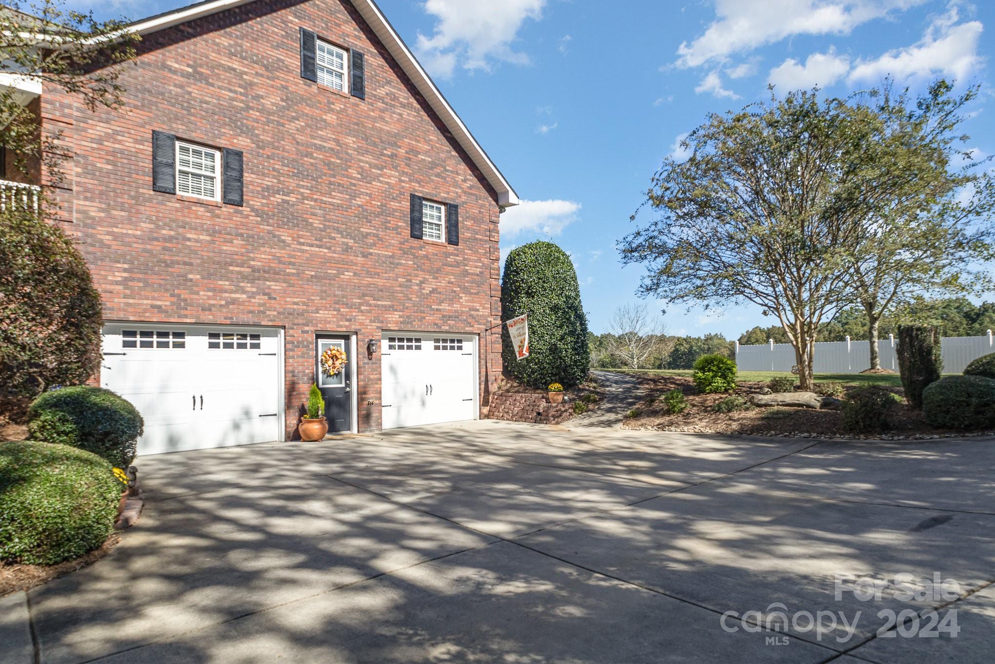 13512 Five Point Road Locust, NC 28097 - Photo 4 of 31 a view of a house with backyard and trees
