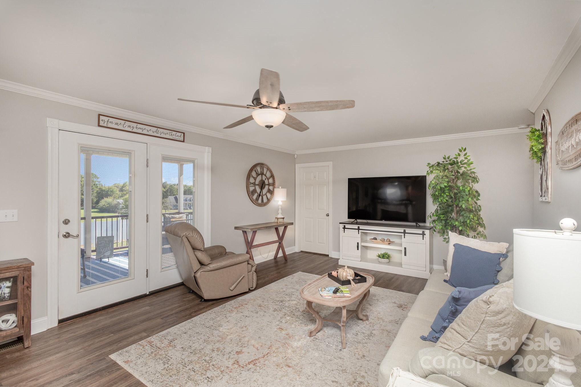 13512 Five Point Road Locust, NC 28097 - Photo 10 of 31 a living room with furniture a flat screen tv and a large window