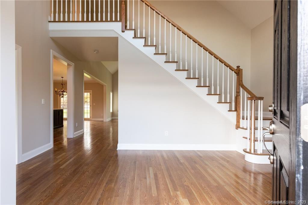 294 Christian Road Middlebury, CT 06762 - Photo 8 of 8 a view of staircase with wooden floor and a rug