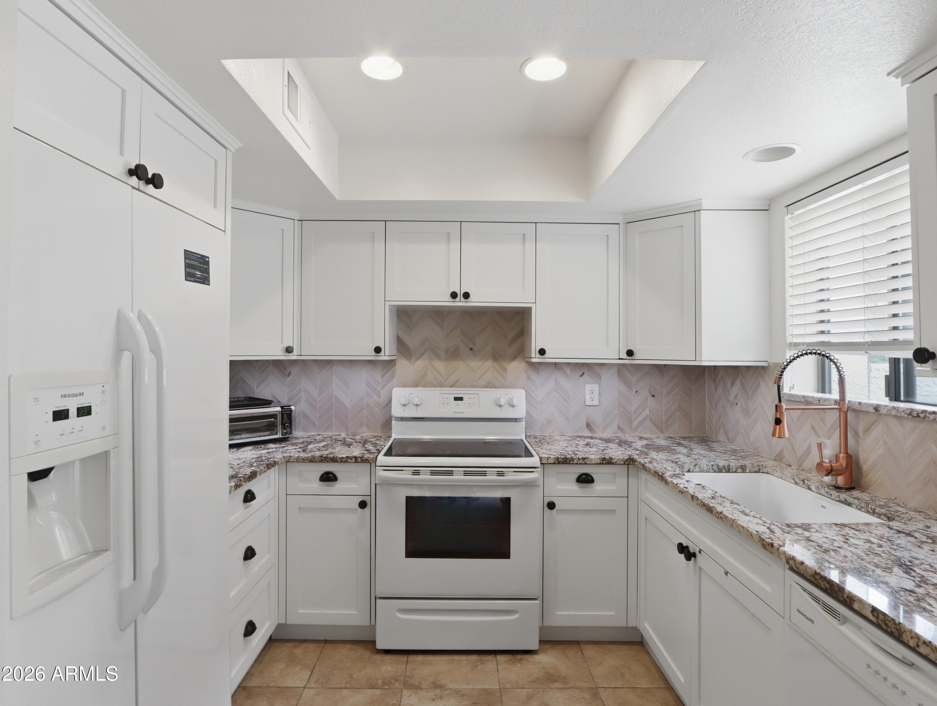 1402 East Osborn Road, Unit 2 Phoenix, AZ 85014 - Photo 9 of 29 a kitchen with cabinets appliances and a window