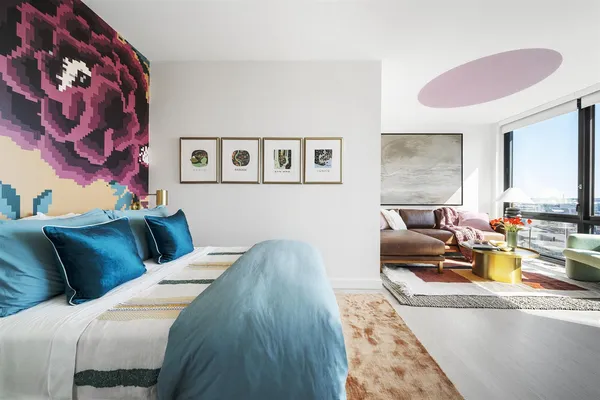 a living room with furniture and painting on the wall