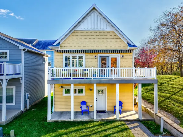 a view of an house with backyard space and balcony
