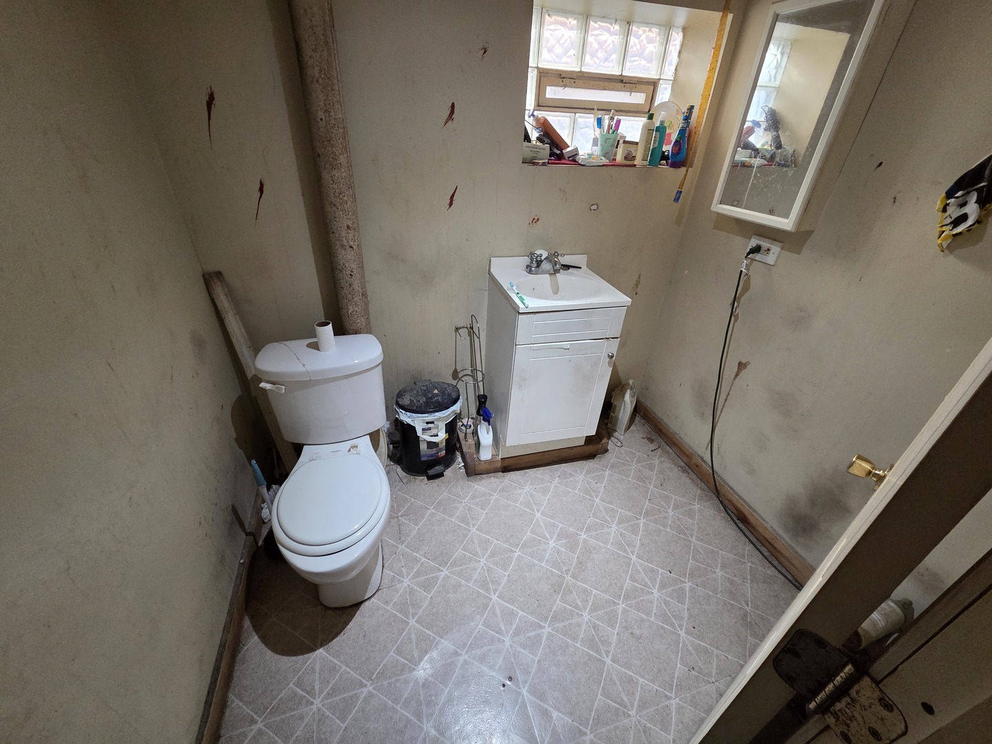 11341 South Normal Avenue Chicago, IL 60628 - Photo 4 of 7 a white toilet sitting next to a bathroom sink and a window