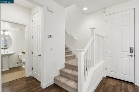 a view of entryway with wooden floor and stairs