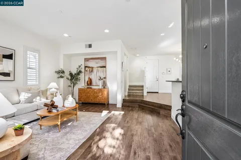 a bedroom with furniture and a wooden floor