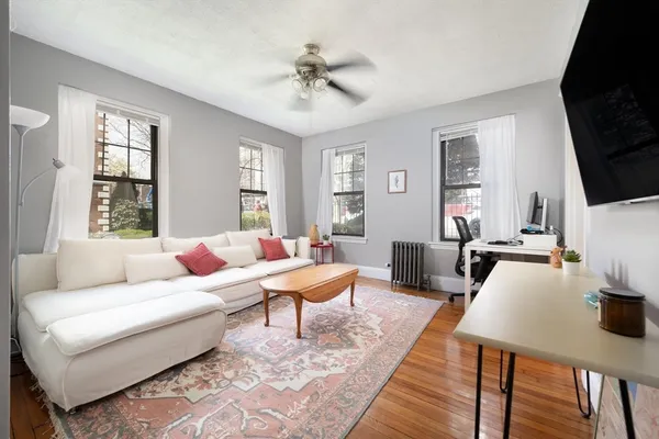 a living room with furniture fireplace and a window