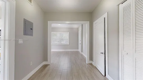 a view of hallway with wooden floor