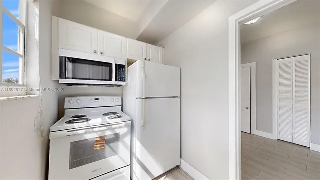 a kitchen with a stove microwave and refrigerator