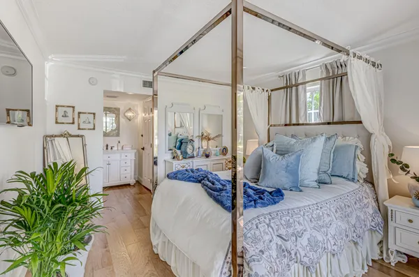 a bedroom with furniture and a large window