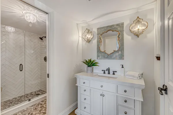 a bathroom with a double vanity sink mirror and shower