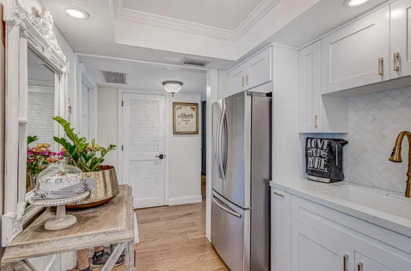 a kitchen with stainless steel appliances a refrigerator and a counter space