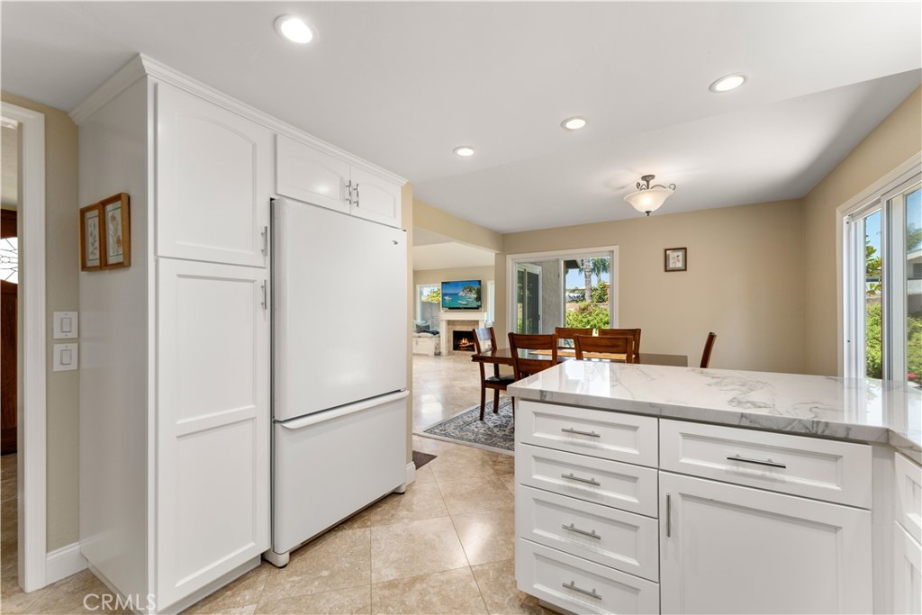 1106 Ridgecrest Circle Costa Mesa, CA 92627 - Photo 12 of 31 a kitchen with a refrigerator and cabinets