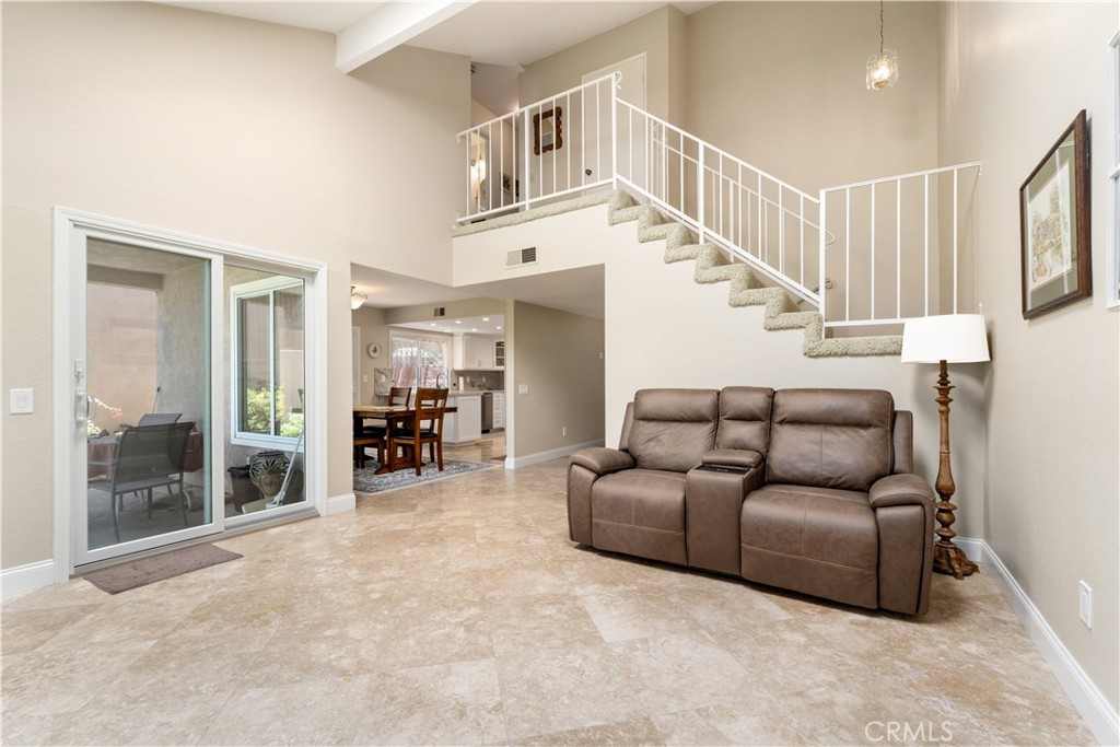 1106 Ridgecrest Circle Costa Mesa, CA 92627 - Photo 16 of 31 a living room with furniture and a large window