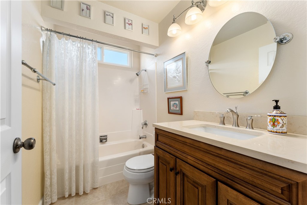 1106 Ridgecrest Circle Costa Mesa, CA 92627 - Photo 18 of 31 a bathroom with a sink a toilet and a mirror