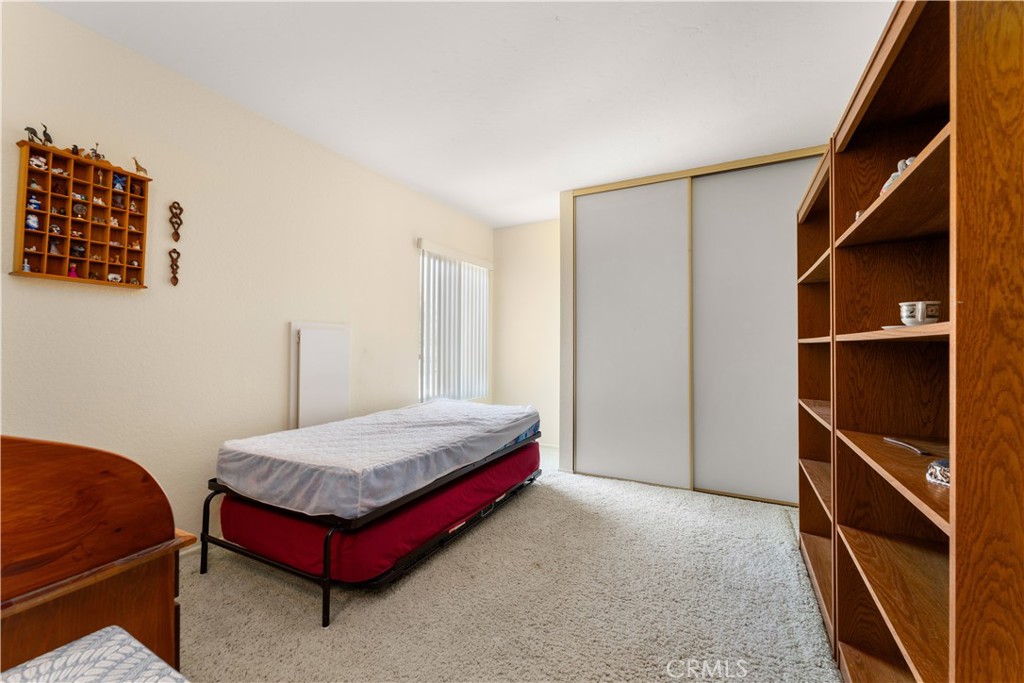 1106 Ridgecrest Circle Costa Mesa, CA 92627 - Photo 21 of 31 a bedroom with a bed and a cabinet