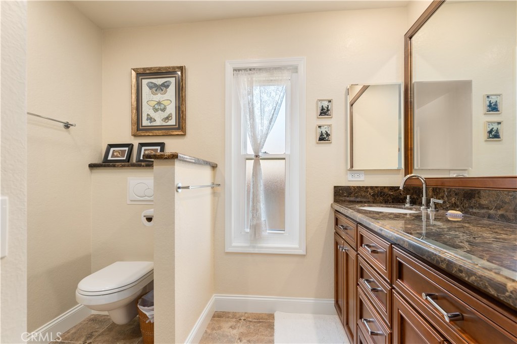 1106 Ridgecrest Circle Costa Mesa, CA 92627 - Photo 23 of 31 a bathroom with a granite countertop sink toilet and shower