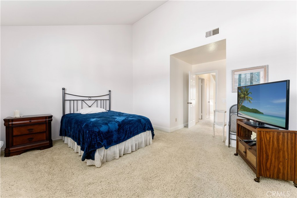 1106 Ridgecrest Circle Costa Mesa, CA 92627 - Photo 26 of 31 a bedroom with a bed and flat screen tv