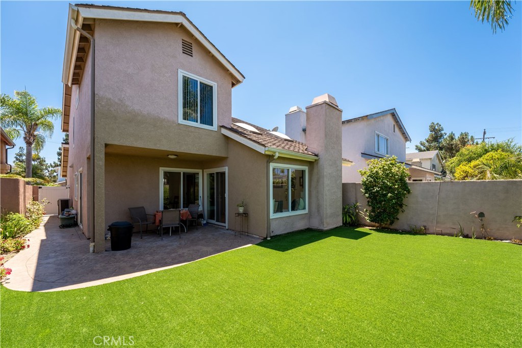 1106 Ridgecrest Circle Costa Mesa, CA 92627 - Photo 30 of 31 a front view of a house with a yard and potted plants