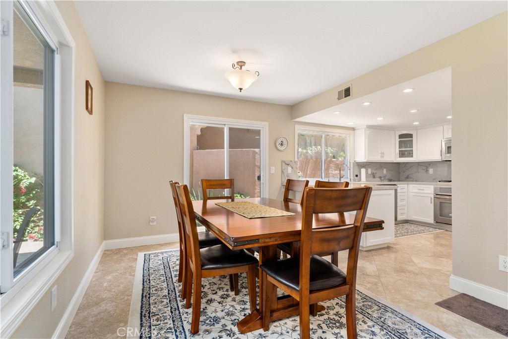 1106 Ridgecrest Circle Costa Mesa, CA 92627 - Photo 8 of 31 a view of a dining room with furniture and a potted plant