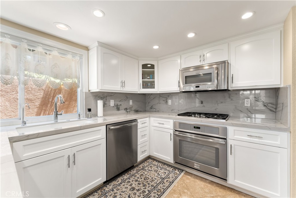 1106 Ridgecrest Circle Costa Mesa, CA 92627 - Photo 10 of 31 a kitchen with a stove a sink and a microwave