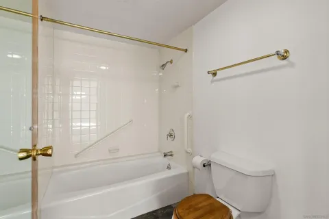a bathroom with a double vanity sink toilet and shower