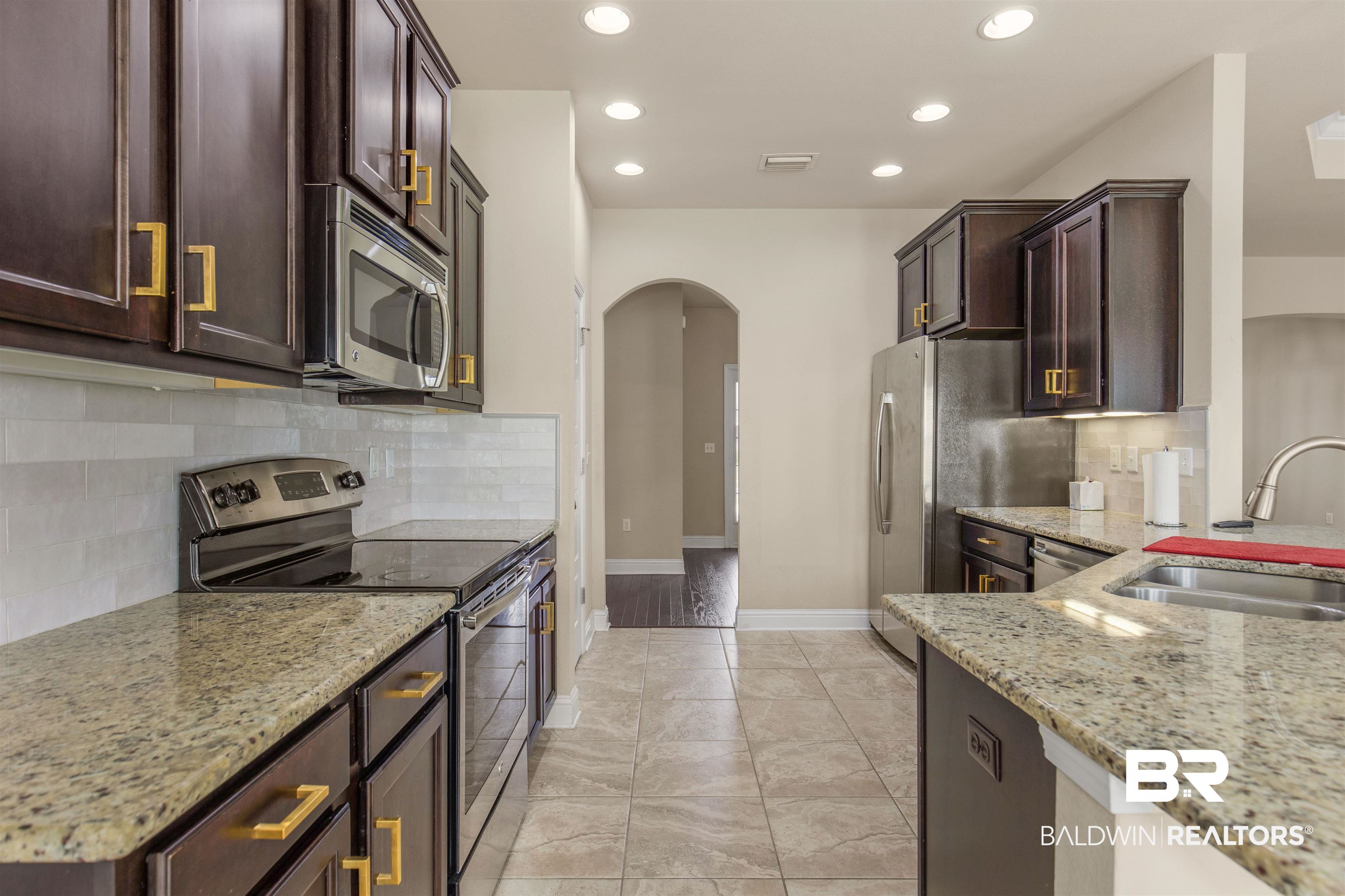 122 Open Field Drive Fairhope, AL 36532 - Photo 10 of 27 Kitchen with light hardwood / wood-style floors, sink, backsplash, and stainless steel appliances