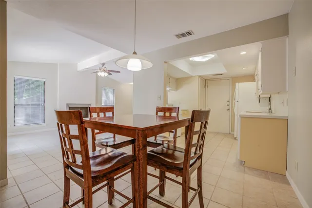 a view of a dining room and a kitchen with a dining table chairs