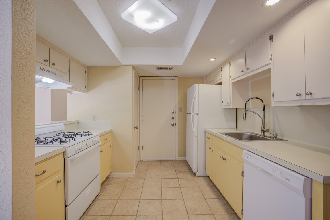 306 Corral Lane, Unit B Austin, TX 78745 - Photo 16 of 33 a kitchen with stainless steel appliances granite countertop a sink stove and cabinets