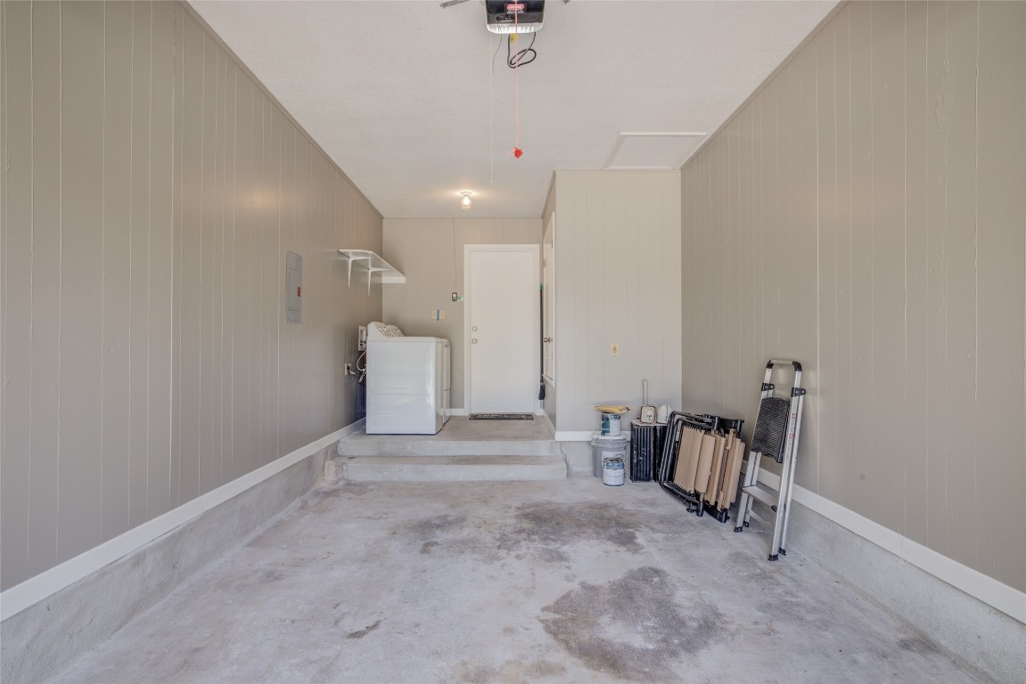 306 Corral Lane, Unit B Austin, TX 78745 - Photo 25 of 33 a view of a hallway with a chair and frames on th wall