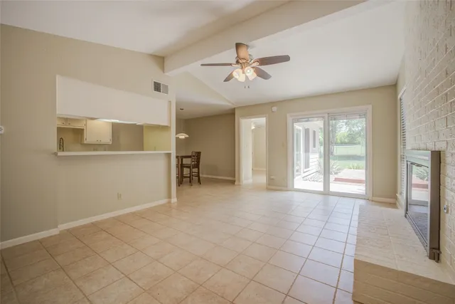 a view of a livingroom with a ceiling fan and window