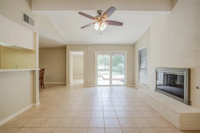 a view of an empty room with a fireplace