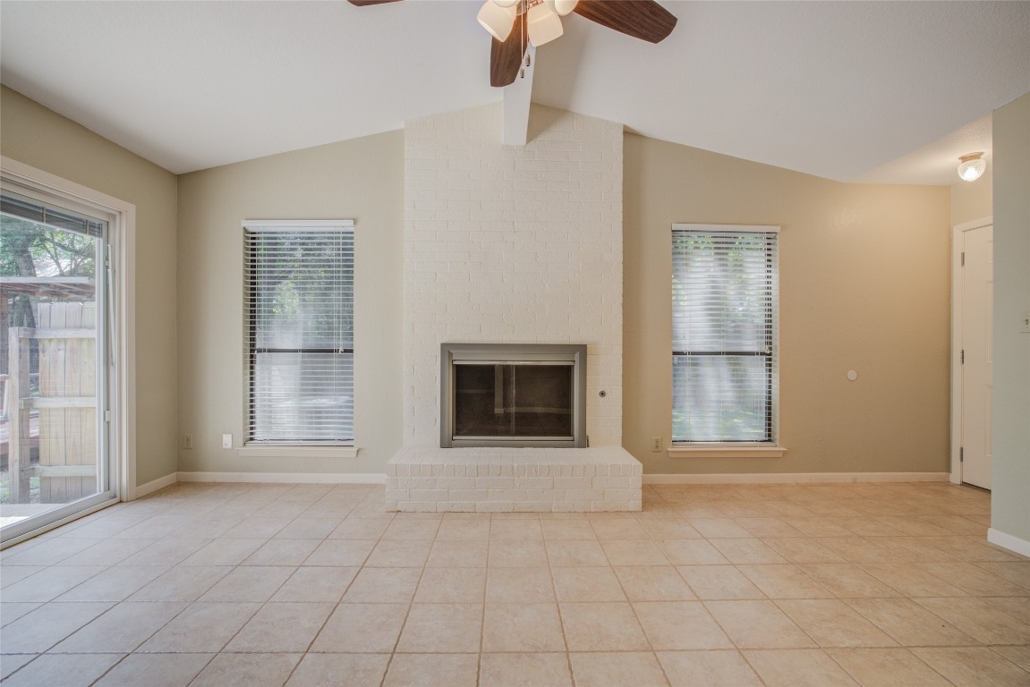 306 Corral Lane, Unit B Austin, TX 78745 - Photo 7 of 33 an empty room with windows and fireplace
