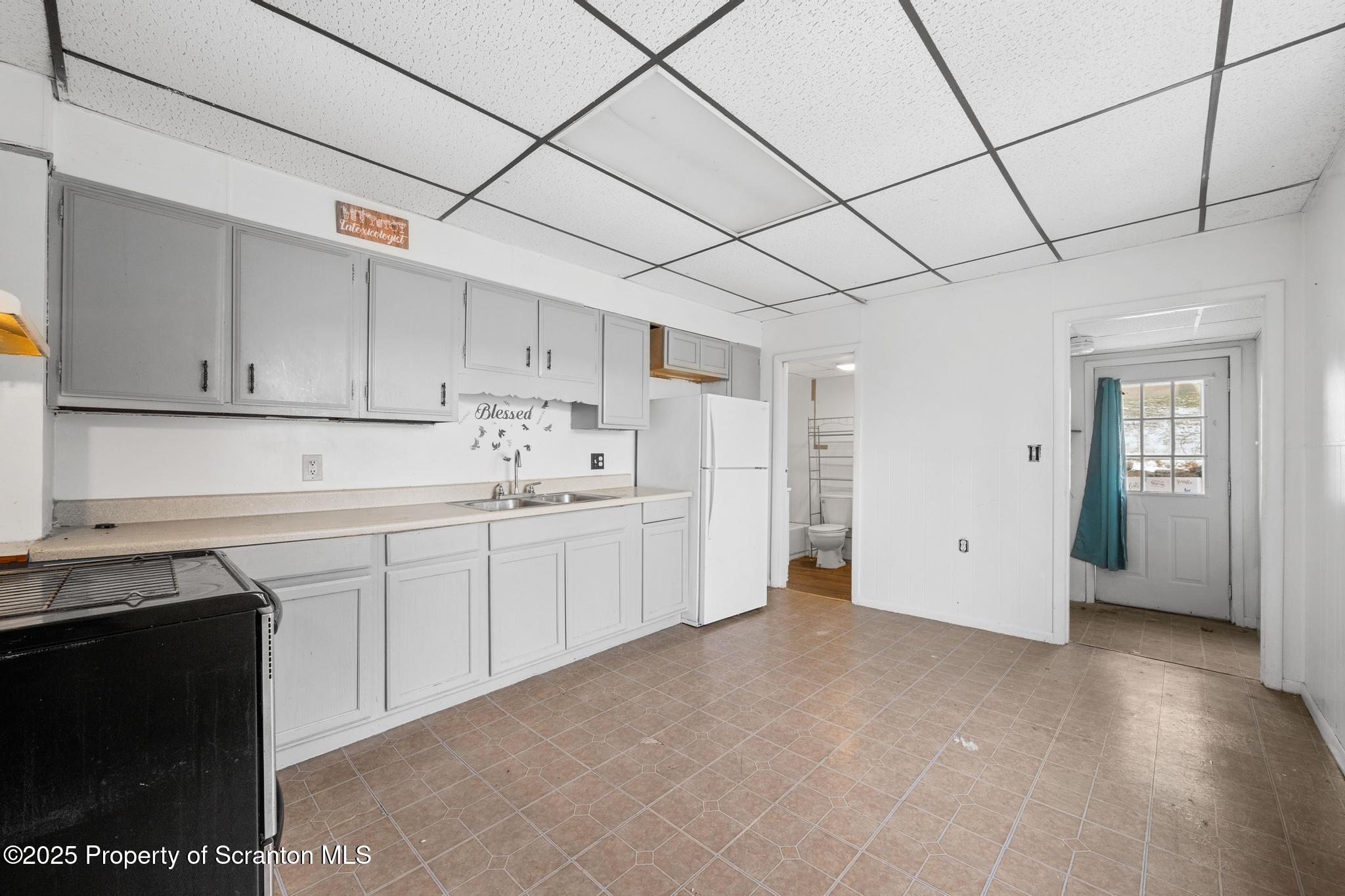729 Moltke Avenue Scranton, PA 18505 - Photo 21 of 43 a kitchen with granite countertop white cabinets and white appliances