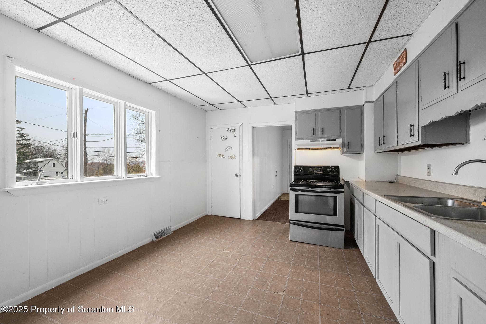 729 Moltke Avenue Scranton, PA 18505 - Photo 22 of 43 a kitchen with stainless steel appliances granite countertop a stove a sink and a refrigerator