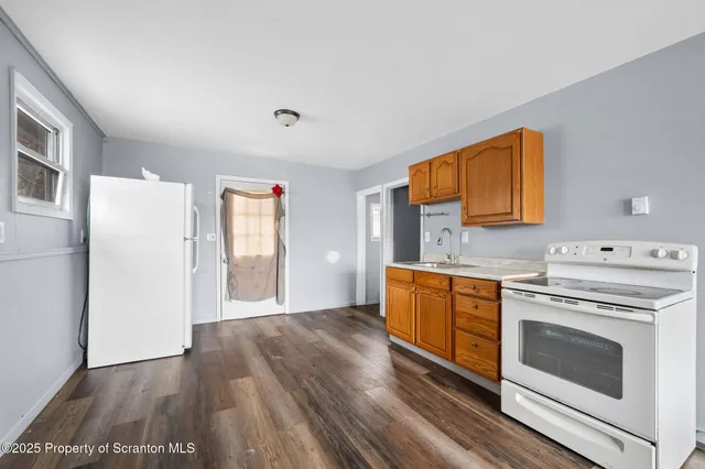 a kitchen with a refrigerator sink and cabinets