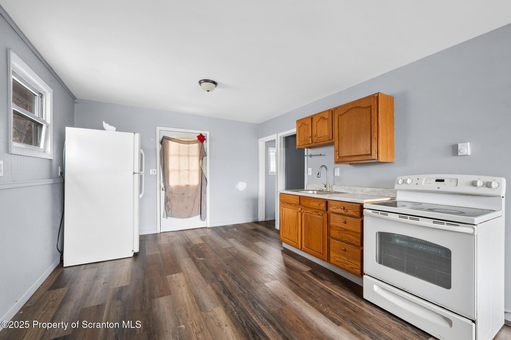 729 Moltke Avenue Scranton, PA 18505 - Photo 28 of 43 a kitchen with wooden floors and white cabinets