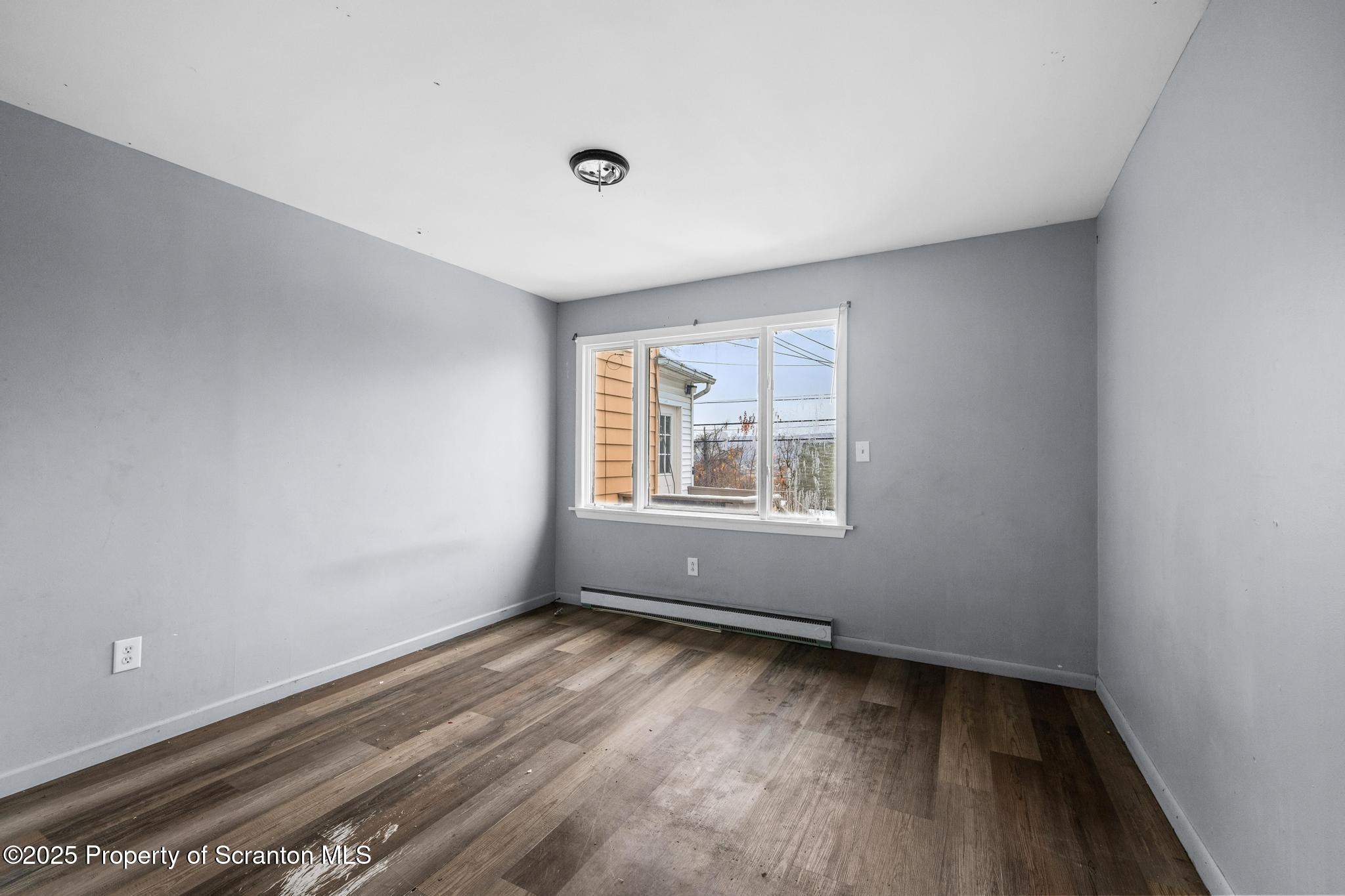 729 Moltke Avenue Scranton, PA 18505 - Photo 29 of 43 wooden floor in an empty room with a window